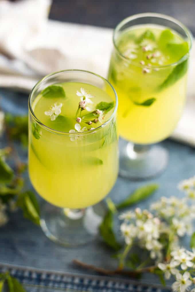 Ginger lemonade served with spring blossoms in two glasses