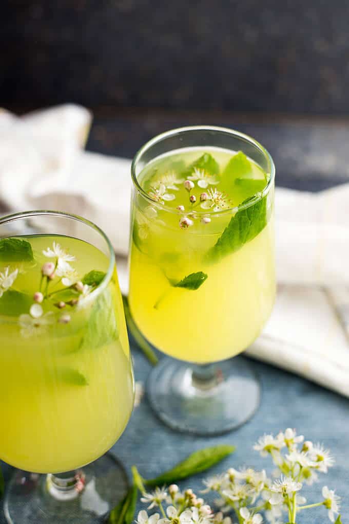 Ginger lemonade served with spring blossoms in two glasses