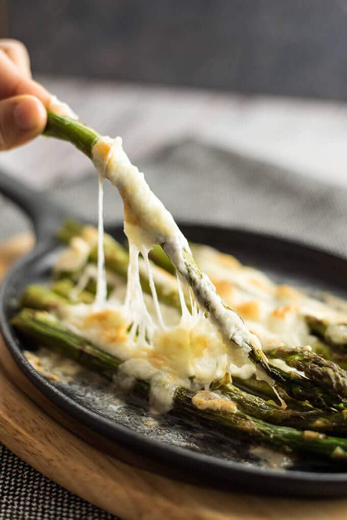 Roasted Asparagus with Mozzarella can tempt anyone. This is always the winner at parties. Simple yet addictive! - giverecipe.com 