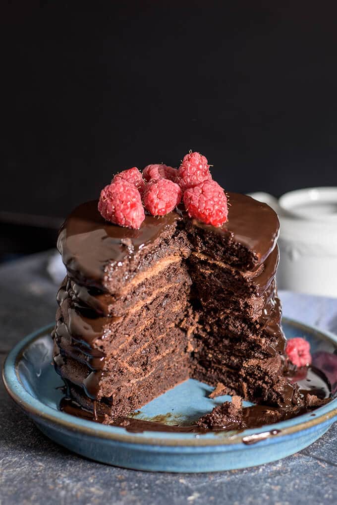 Half eaten decadent chocolate pancakes on a blue plate