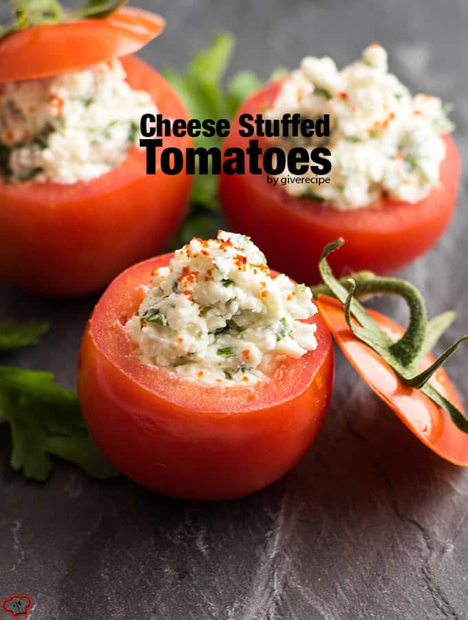 Looking for the easiest appetizer recipe ever? Make these Cheese Stuffed Tomatoes with 6 simple ingredients. No need for cooking or baking. Ready in 5 minutes! #stuffedtomatoes #appetizer Cheese Stuffed Tomatoes served on a black stone