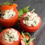 Cheese Stuffed Tomatoes served on a black stone