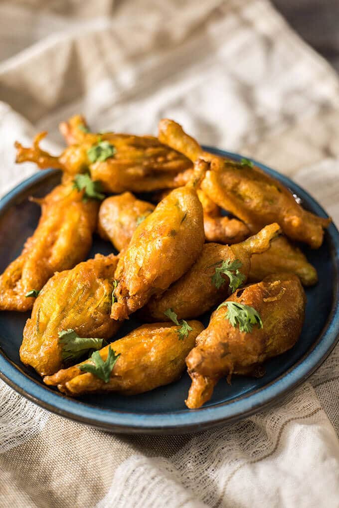 Zucchini blossoms stuffed with cooked shrimps and cheese. Battered and deep fried. These are TO DIE FOR! Disappear in a minute! - giverecipe.com