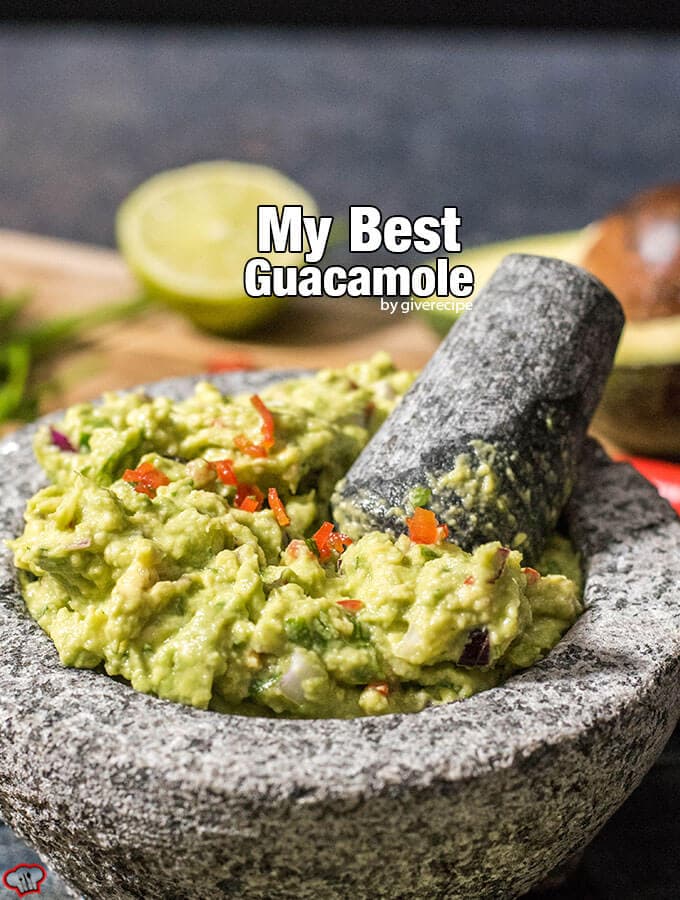 This is my BEST guacamole ever. Spicy without jalapenos. You will love the heat coming from red chilies in it. #guacamolerecipe #spicyguacamole #bestguacamole Spicy guacamole with chilies in a guac bowl