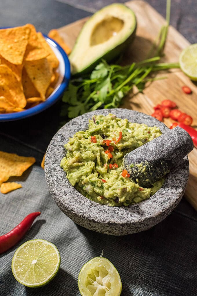 This is my BEST guacamole ever. Spicy without jalapenos. You will love the heat coming from red chilies in it. #guacamolerecipe #spicyguacamole #bestguacamole How to make guacamole spicy in a guac bowl