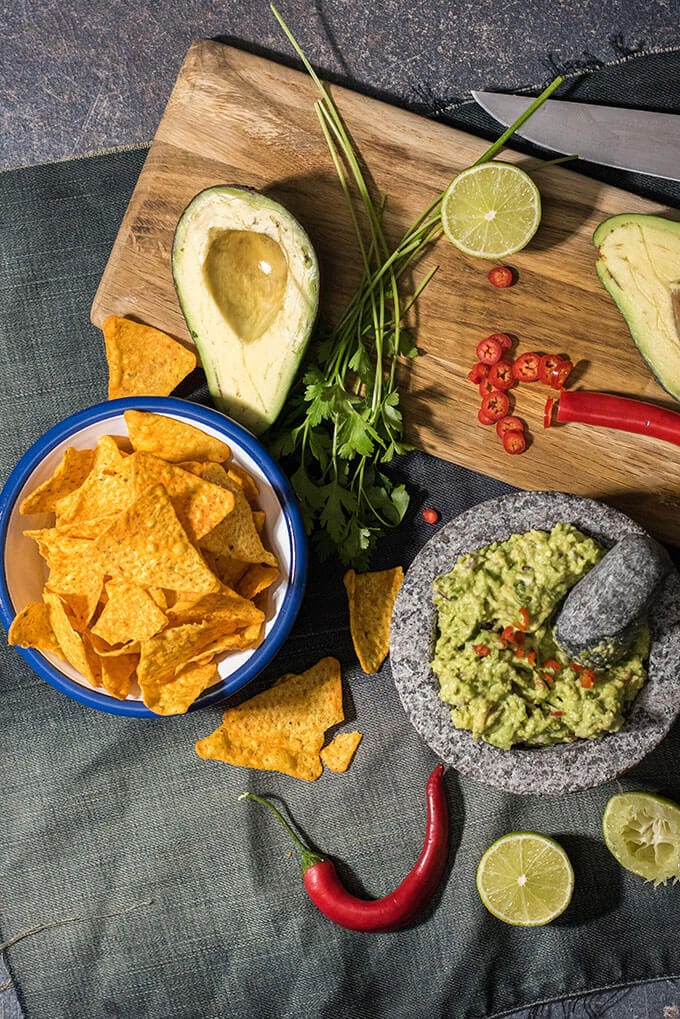 This is my BEST guacamole ever. Spicy without jalapenos. You will love the heat coming from red chilies in it. #guacamolerecipe #spicyguacamole #bestguacamole How to keep guacamole from turning brown