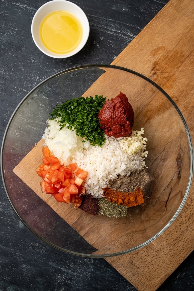 Dolma filling ingredients in a large glass bowl.