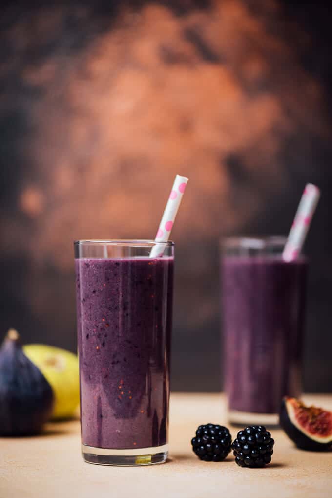 Blackberry Fig Kefir Smoothie in tall glasses with white and pink straws