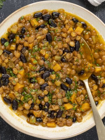 Black bean lentil soup in a white bowl.