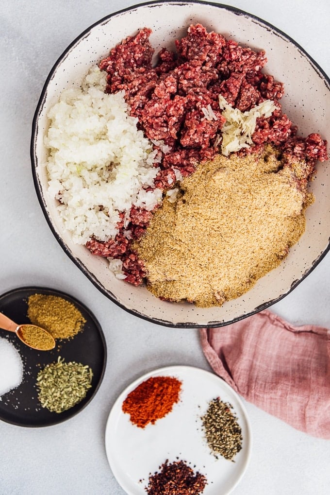 Homemade Turkish Meatballs are spicy, tender and perfectly juicy. It’s not a secret any more to make meatballs at home. #turkishfood #meatballs #meatballsrecipe #middleeasternfood #kofta #kofte Making Turkish kofta recipe in a ceramic bowl.