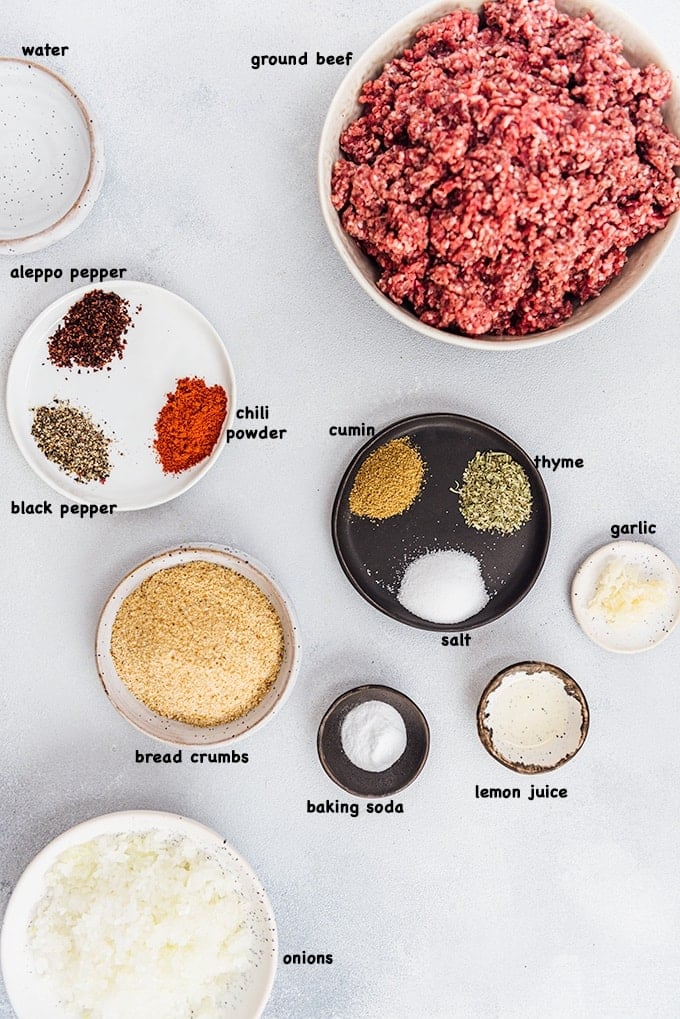 Homemade Turkish Meatballs are spicy, tender and perfectly juicy. It’s not a secret any more to make meatballs at home. #turkishfood #meatballs #meatballsrecipe #middleeasternfood #kofta #kofte Ground beef, spices, garlic, bread crumbs, onions, baking soda and lemon juice photographed from top view.