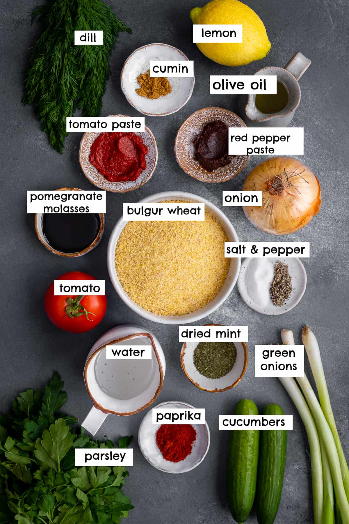 Bulgur salad ingredients on a dark backdrop.