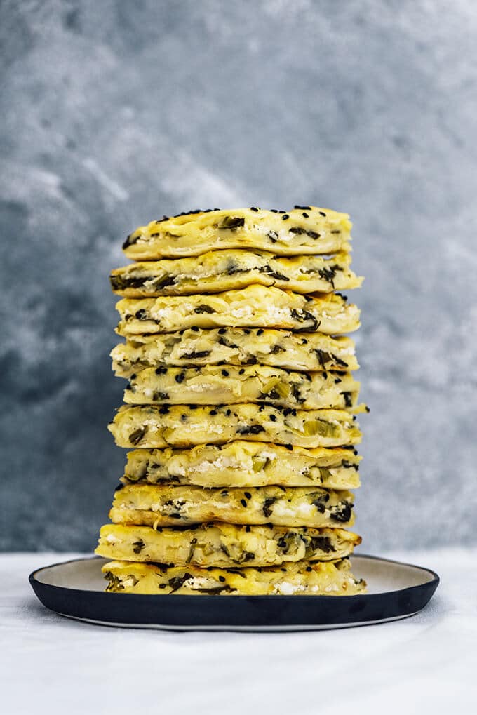 A big stack of Turkish borek slices photographed from front view