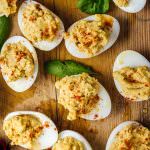 Hummus Deviled Eggs are the combination of two addictive appetizers. Creamy hummus replaces mayonnaise and makes perfect mayo-free deviled eggs. They will disappear so fast that everyone will beg for more.