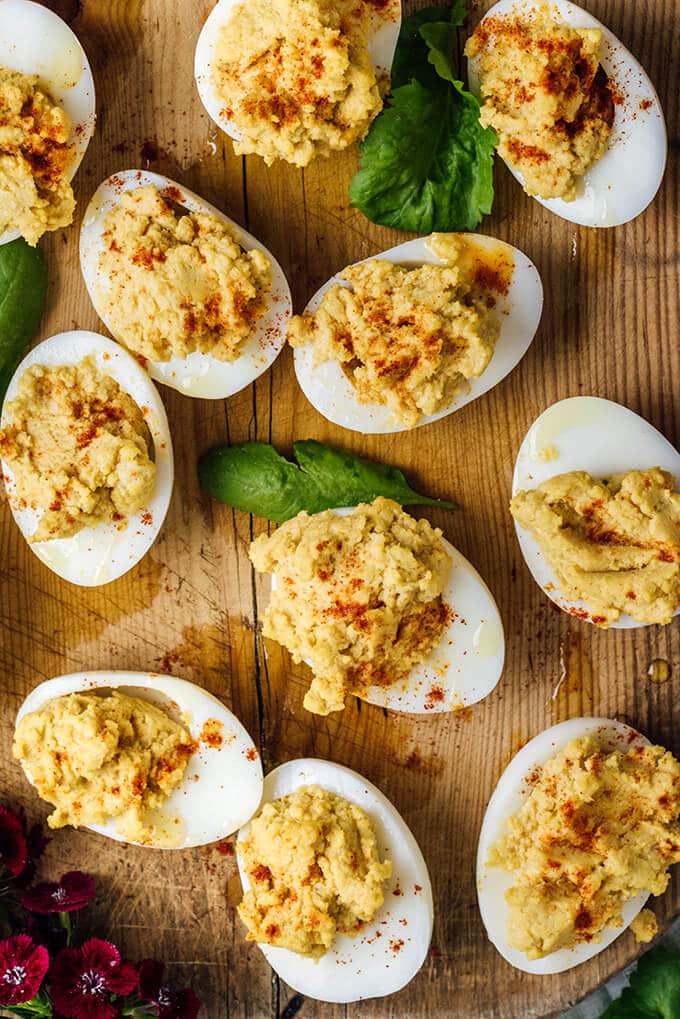 Hummus Deviled Eggs are the combination of two addictive appetizers. Creamy hummus replaces mayonnaise and makes perfect mayo-free deviled eggs. They will disappear so fast that everyone will beg for more.