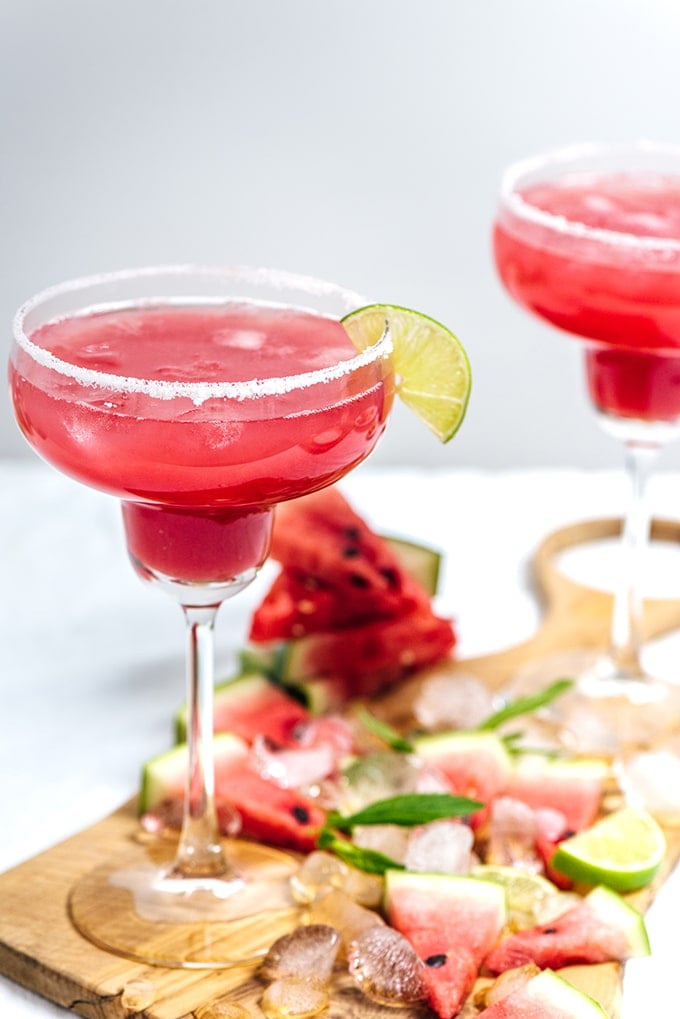 Mint Watermelon Margarita in margarita glasses and watermelon slices on the side.