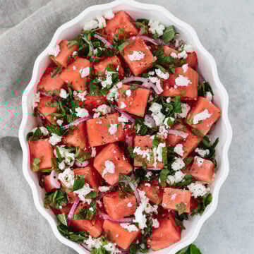 Watermelon Feta Mint Salad with red onion is a super refreshing summertime recipe. The simple balsamic dressing in this unexpected combination of flavors takes the salad to the next level.