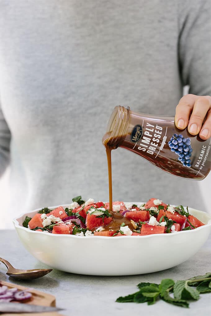 Watermelon Feta Mint Salad with red onion is a super refreshing summertime recipe. The simple balsamic dressing in this unexpected combination of flavors takes the salad to the next level.