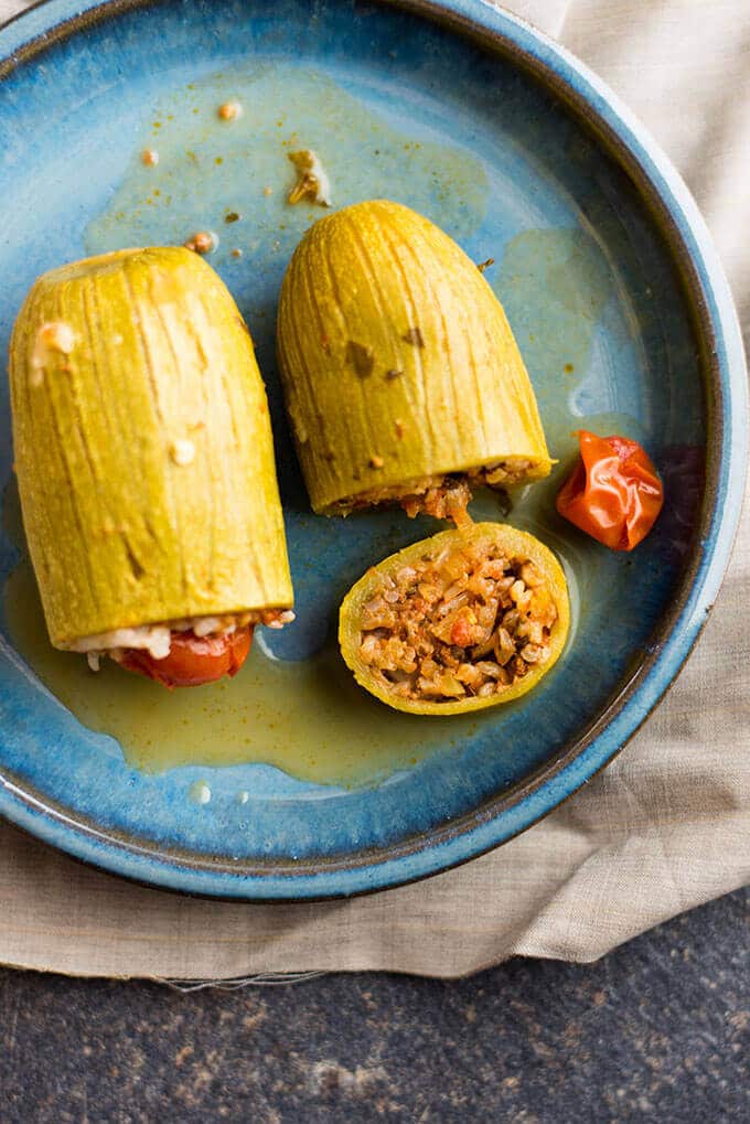 Turkish style rice stuffed zucchinis on a blue plate.