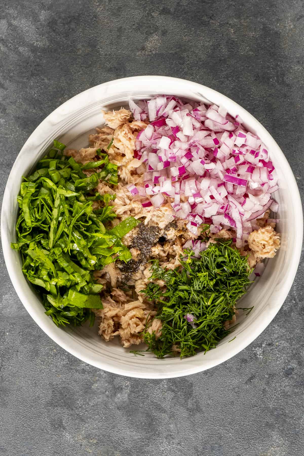 Tuna salad ingredients in a bowl.