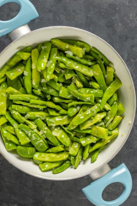 Green beans braising in a pot.