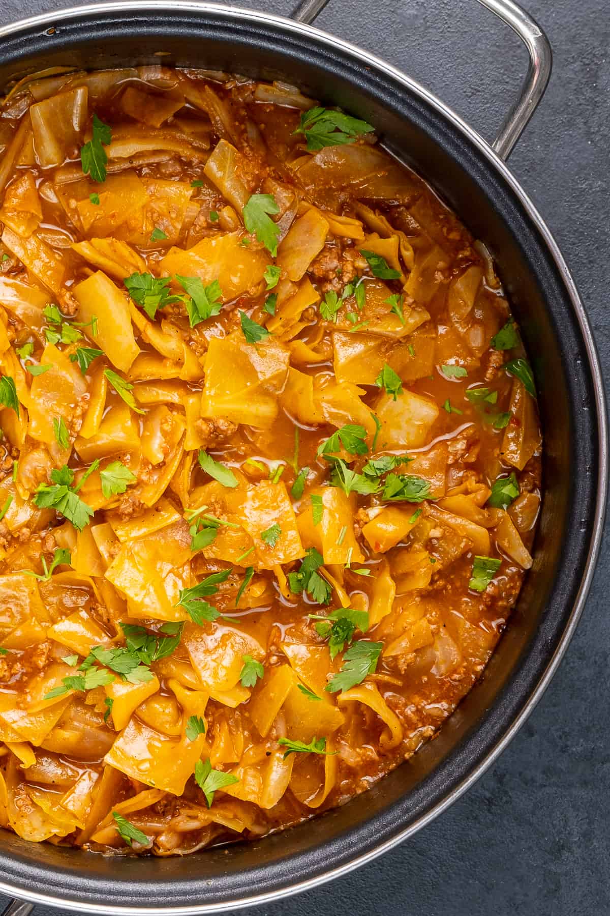 Kapuska in a large pan, garnished with chopped parsley.