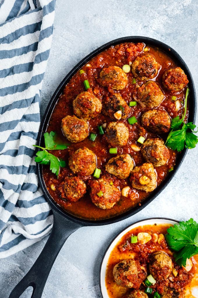 Tomato Chili Sauce Meatballs in a cast iron pan.