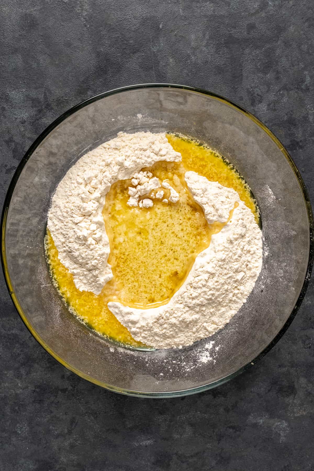 Cake mix and melted butter in a glass mixing bowl.