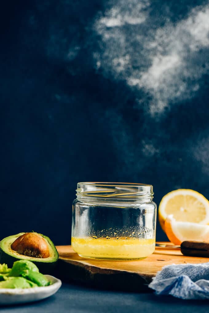 Lemon juice and onion in a glass jar for avocado salad dressing