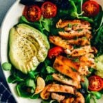 Keto chicken salad with avocado and herbs in a ceramic bowl