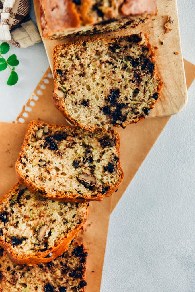 Zucchini bread with chocolate chips sliced on brown paper