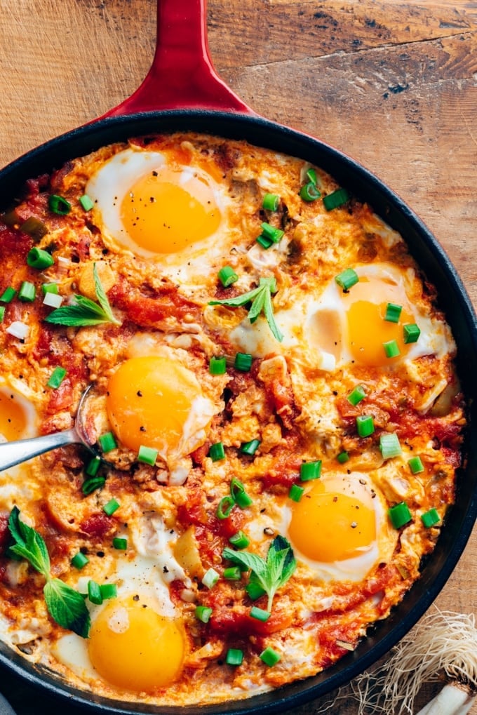 Turkish menemen recipe with eggs and tomatoes in a pan.