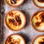 Baked sütlaç (Turkish rice pudding) in small clay bowls with caramelized tops.