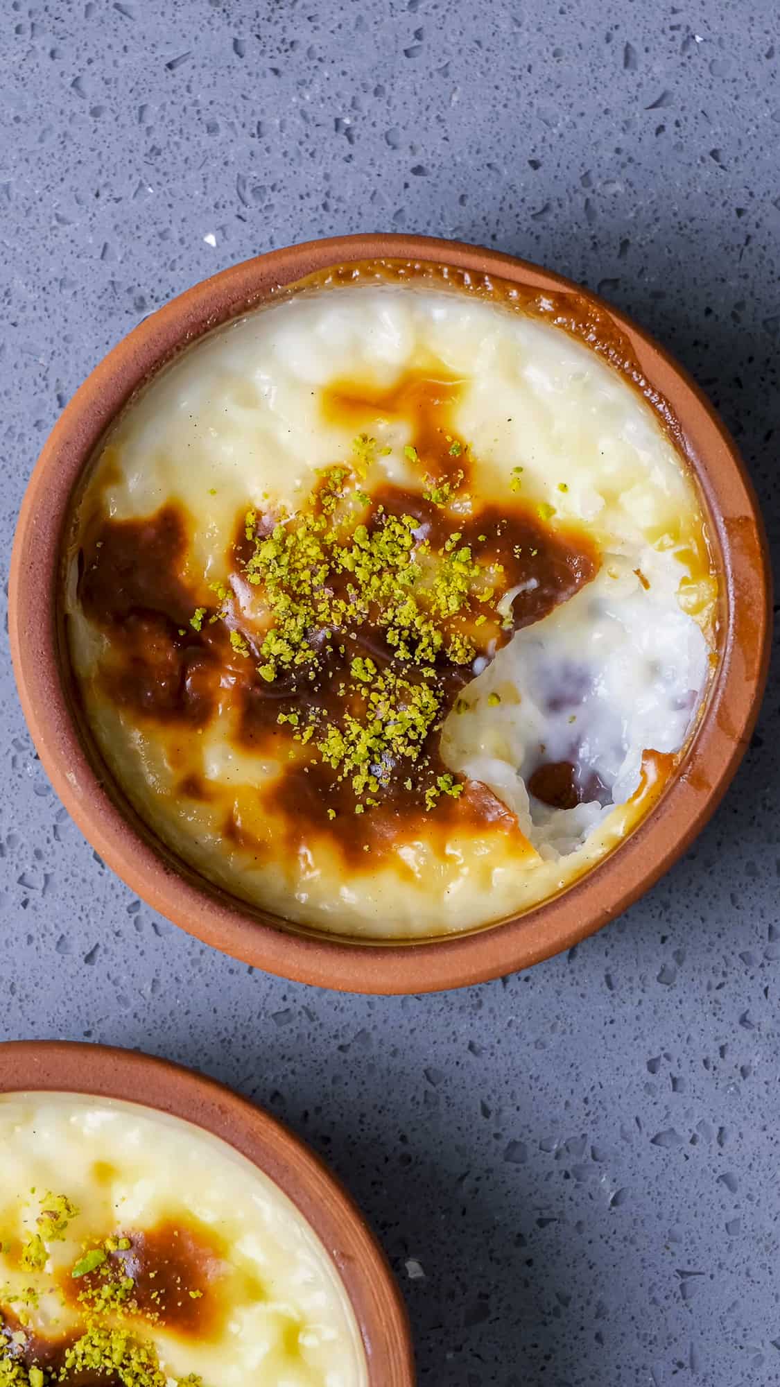 Rice pudding with a golden top in a clay pot.