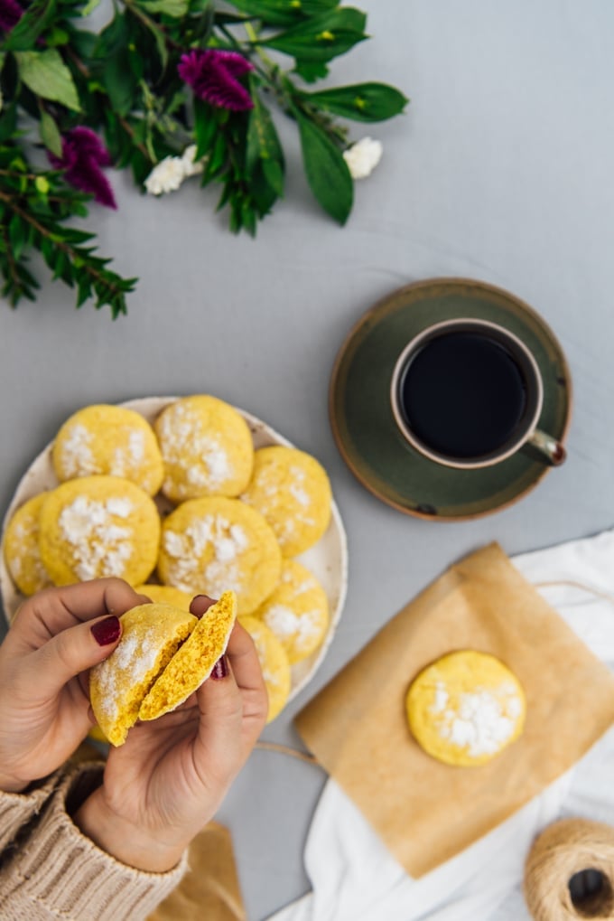 Hands showing the inside of a lemon crinkle cookie