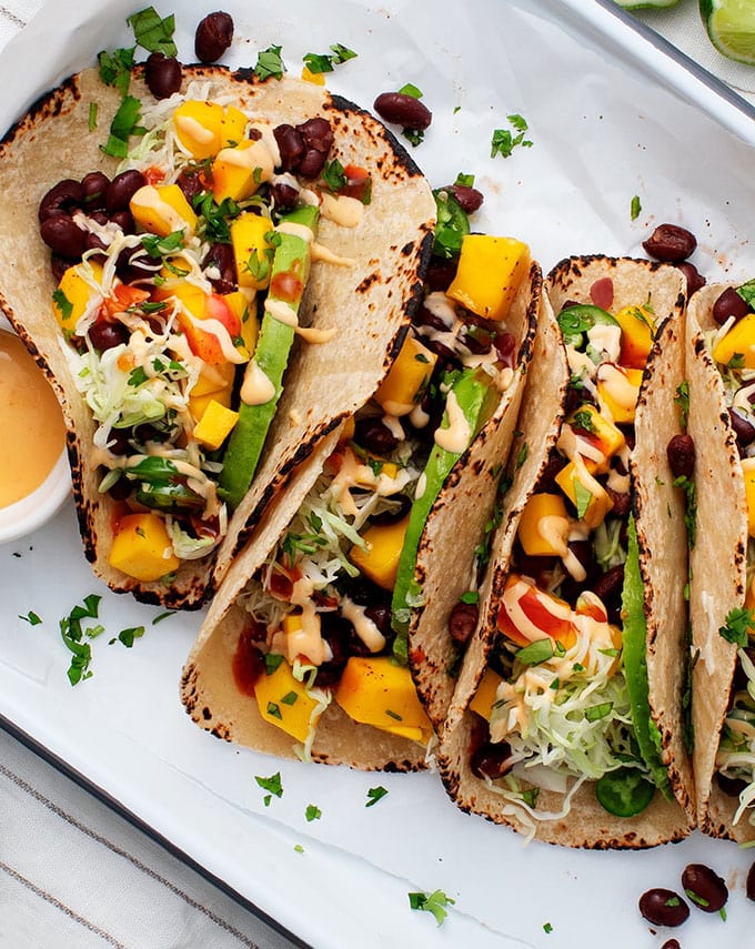 Vegetarian game day tacos with mango, black beans and avocado