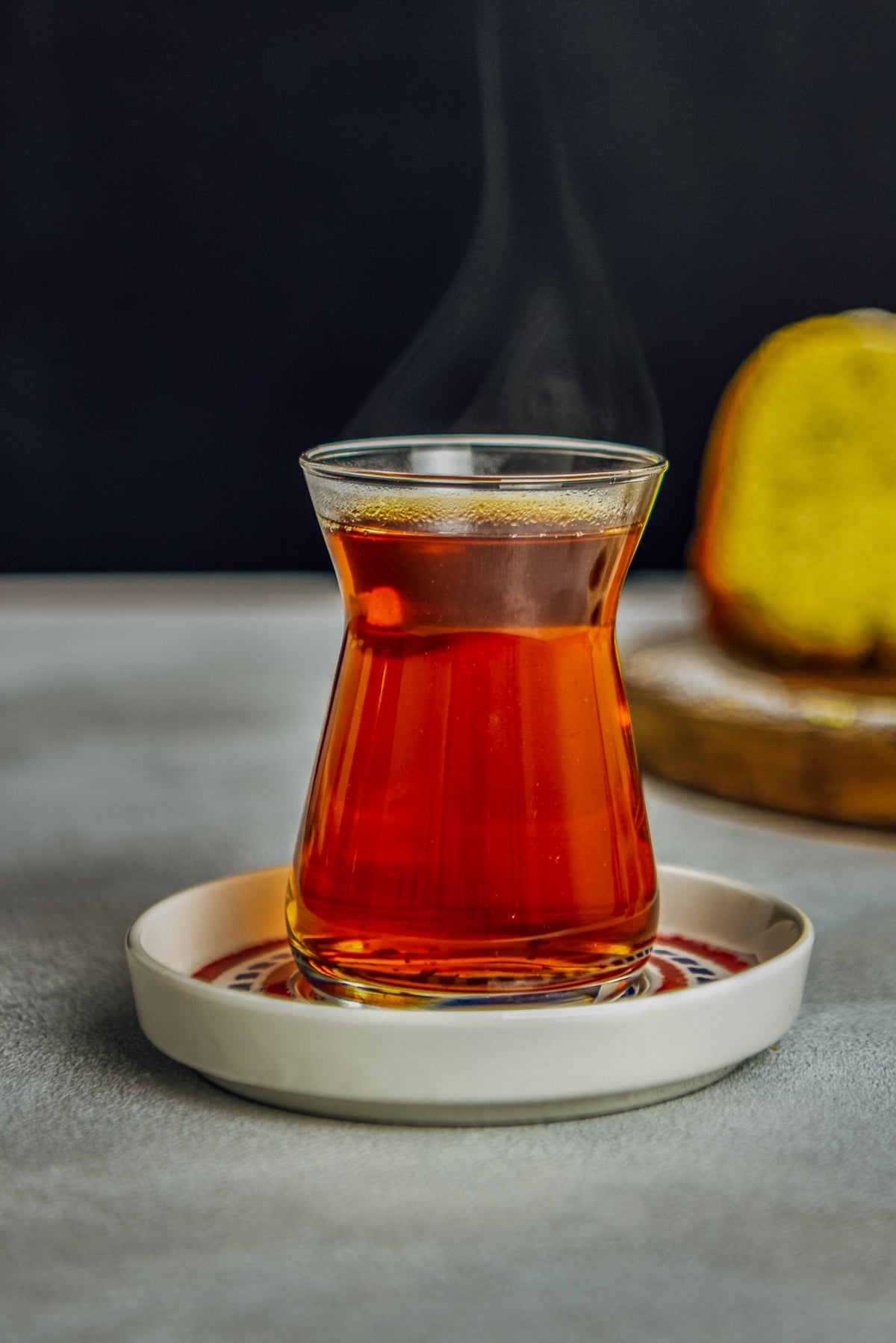 Hot Turkish tea in its traditional tea glass and saucer.