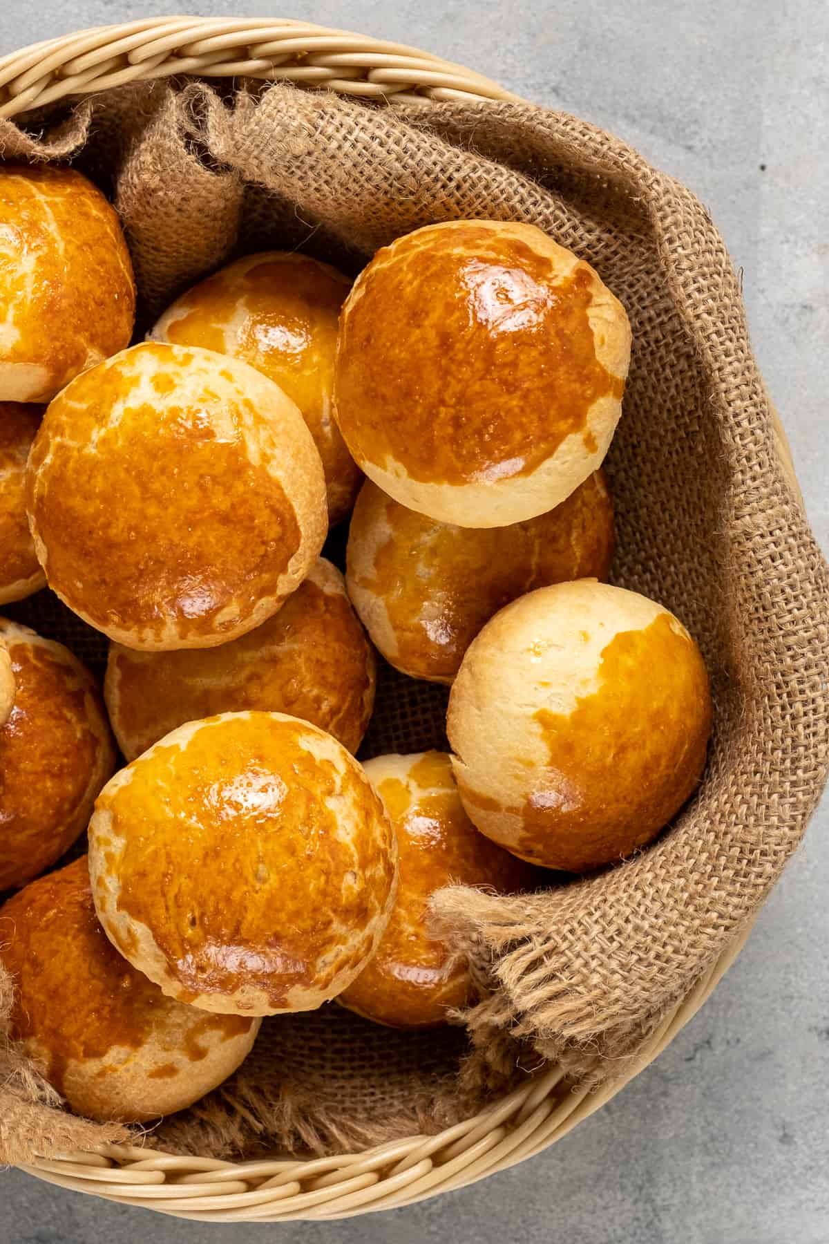 Dinner rolls in a basket shot from top view.