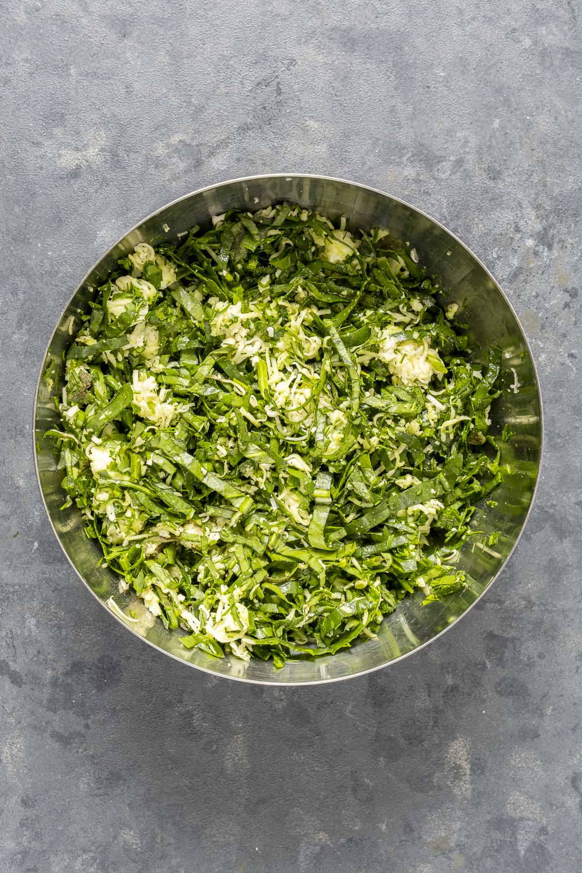 Spinach and cheese filling in a bowl.