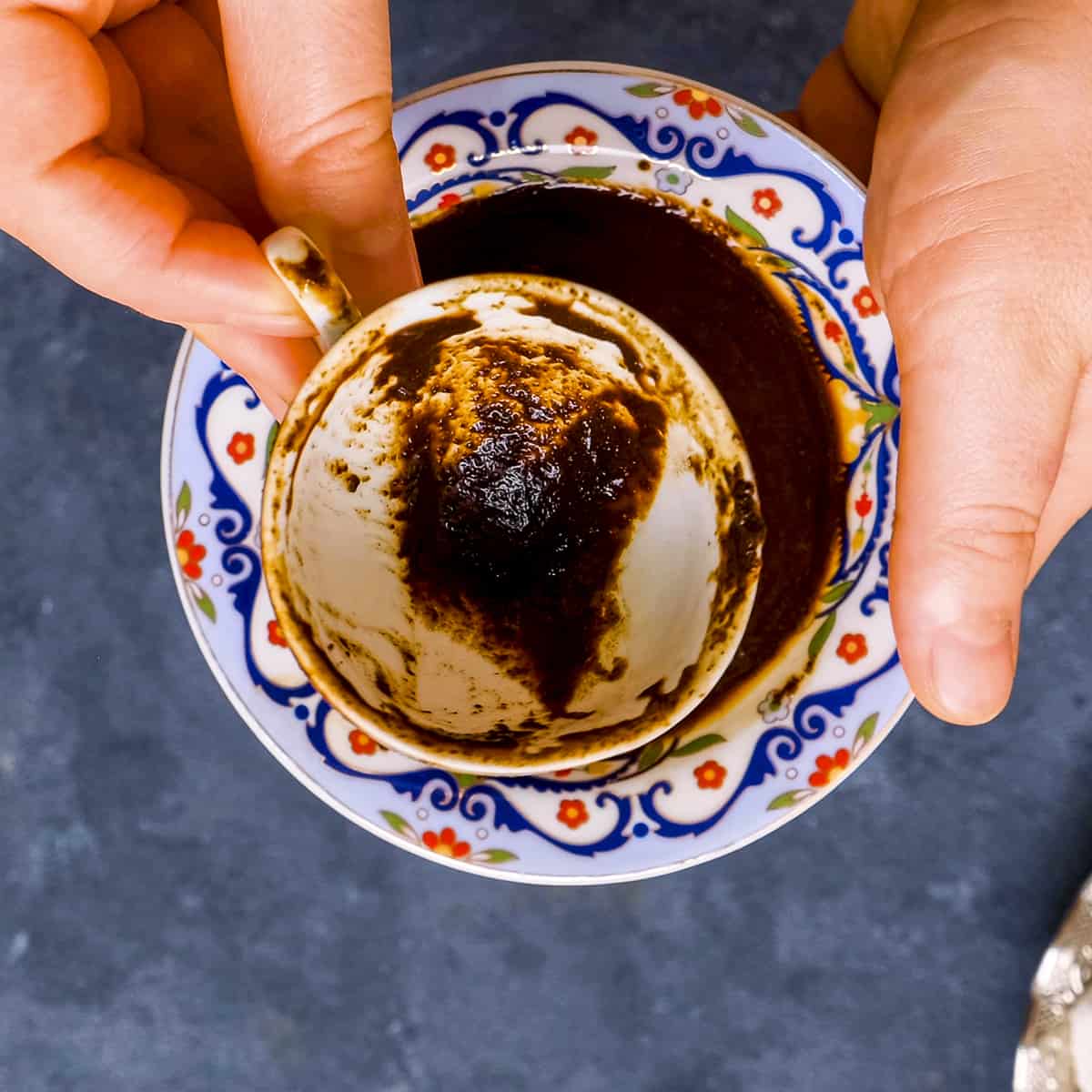 Hands showing the inside of a Turkish coffee cup for fortune telling.