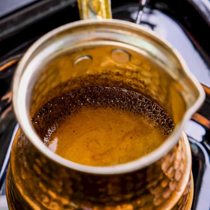 Turkish coffee making in a copper pot.