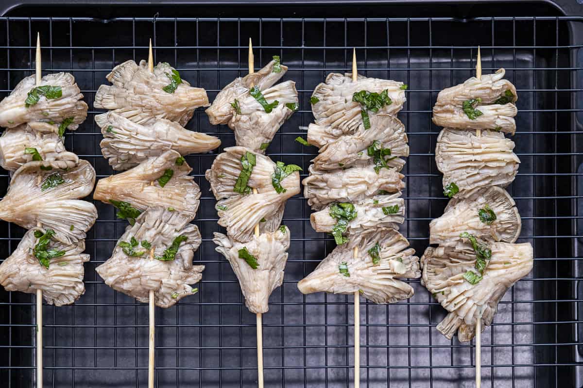 Marinated oyster mushroom skewers on the grill.