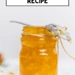 ar of homemade lemon jam with a spoon resting on top.