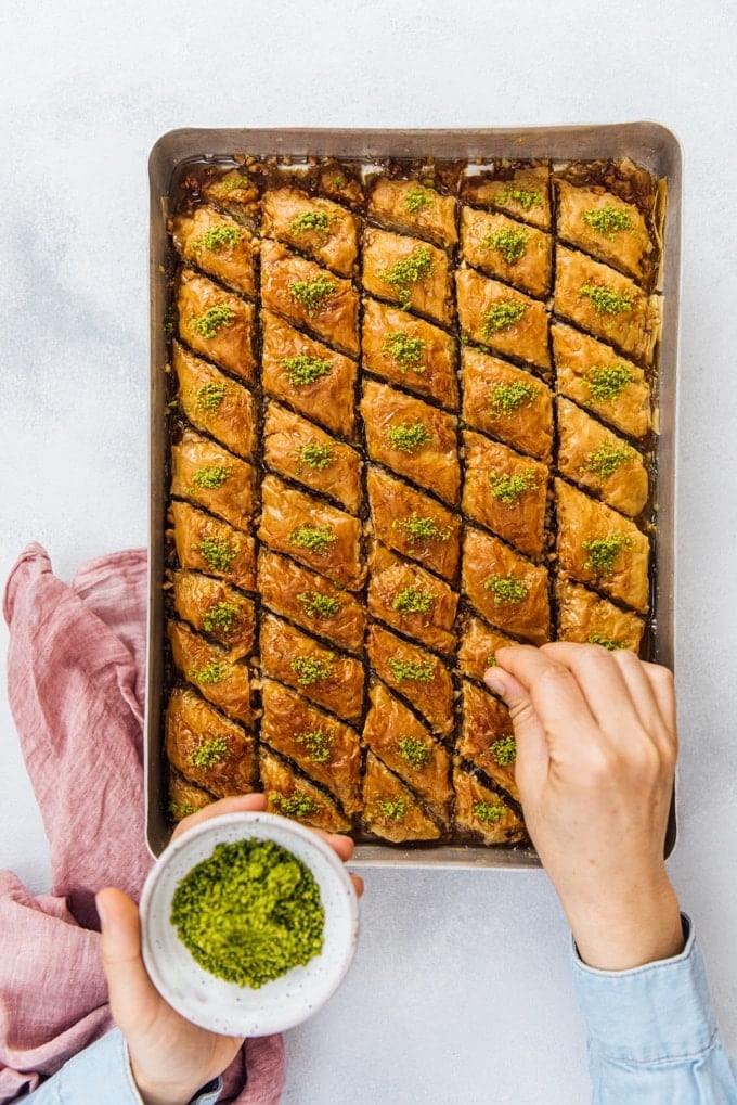 Sprinkling Turkish pistachios over Turkish baklava