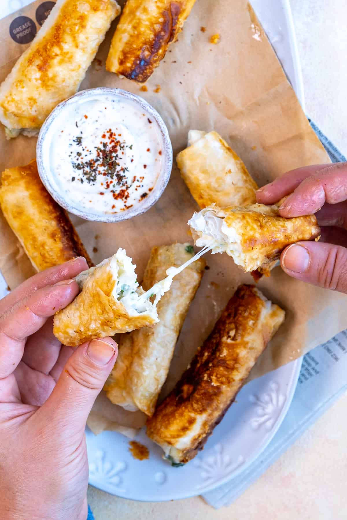 Hands showing the melty cheese inside siaga bore