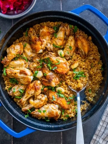 Chicken wings with bulgur served with Turkish pickled red cabbage.