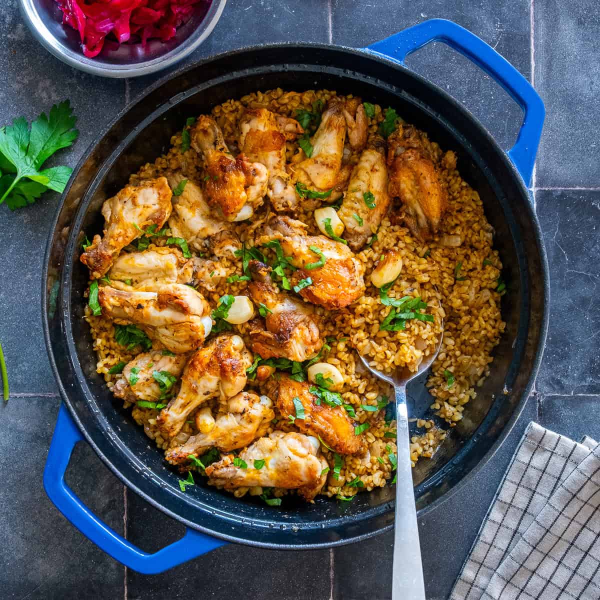 Chicken wings with bulgur served with Turkish pickled red cabbage.