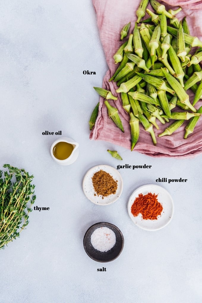 Roasted okra recipe ingredients on a light background.