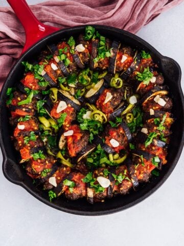 Baked eggplant kebab with meatballs in cast iron skillet