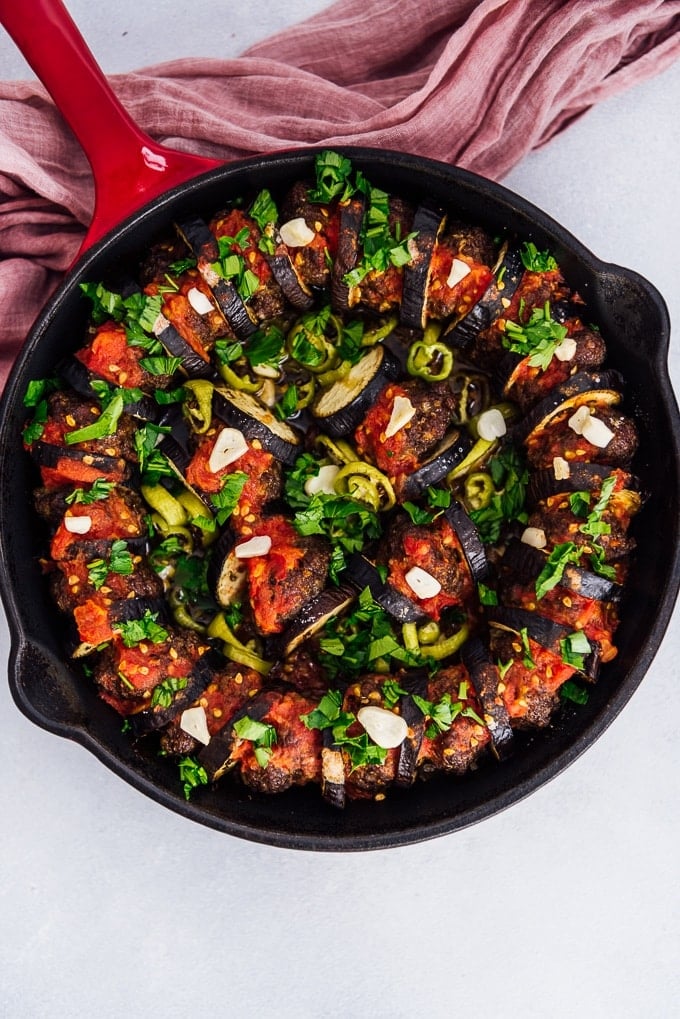 Baked eggplant kebab with meatballs in cast iron skillet